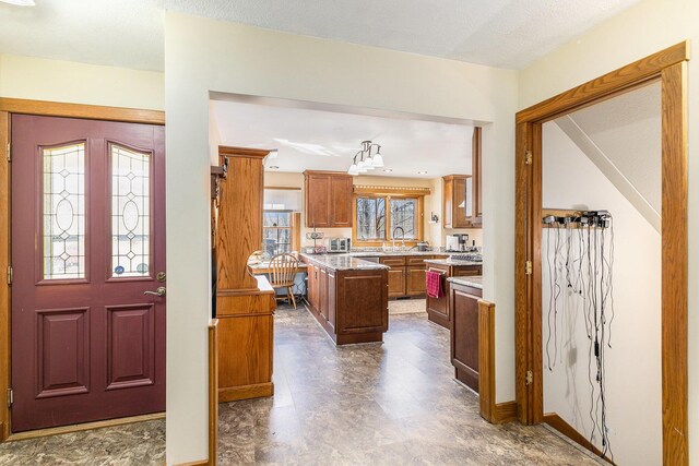 kitchen featuring brown cabinets and a sink