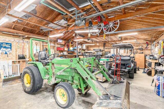 garage with a workshop area and a garage door opener