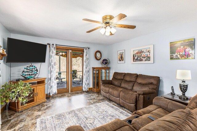 living area featuring baseboards, french doors, and a ceiling fan
