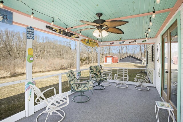 view of patio with a storage shed, an outbuilding, and a ceiling fan