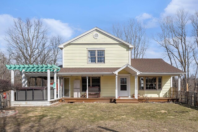 view of front of house featuring fence, a front lawn, a porch, and a pergola