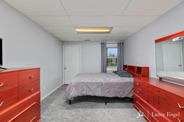carpeted bedroom with a drop ceiling