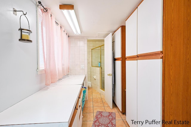 full bath with vanity, tile patterned flooring, and a shower stall