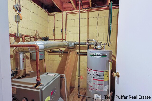 utility room featuring water heater and a heating unit