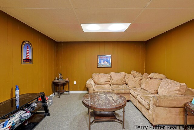 carpeted living room featuring a paneled ceiling