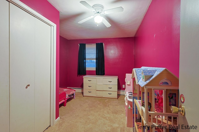 playroom featuring a baseboard heating unit, a ceiling fan, and carpet