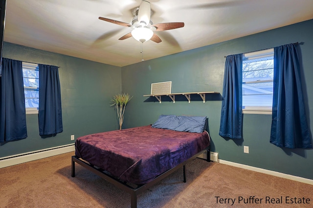 carpeted bedroom with a baseboard heating unit, ceiling fan, baseboards, and multiple windows
