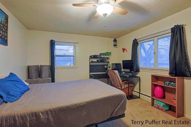 bedroom with a baseboard heating unit, a ceiling fan, and carpet floors