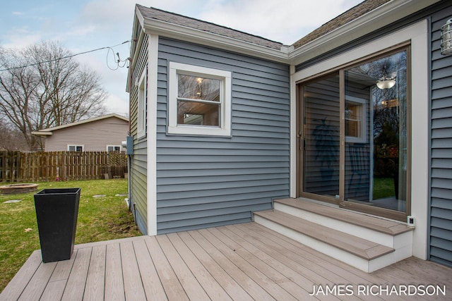 wooden terrace featuring entry steps, a lawn, and fence