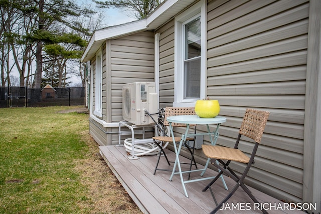 wooden deck featuring fence, ac unit, a yard, and a trampoline