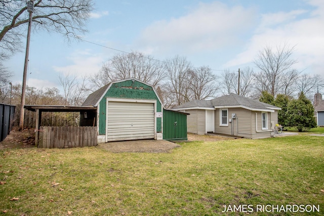 garage with fence and a detached garage