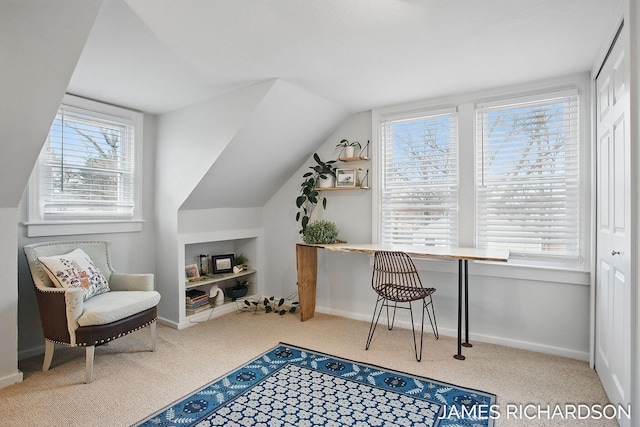 carpeted home office with lofted ceiling and baseboards
