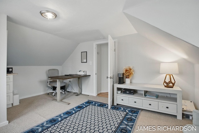 interior space with baseboards, lofted ceiling, and light colored carpet