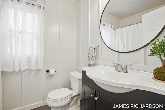 bathroom with toilet and vanity