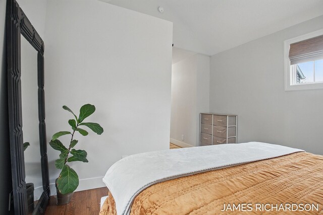bedroom featuring baseboards and wood finished floors