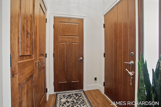 interior space with wood finished floors and baseboards
