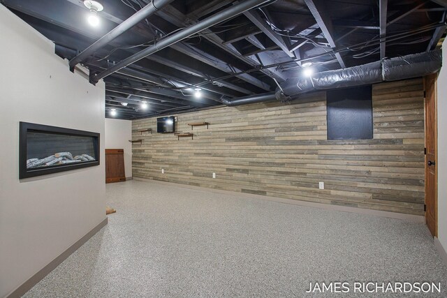 finished basement with wooden walls and baseboards