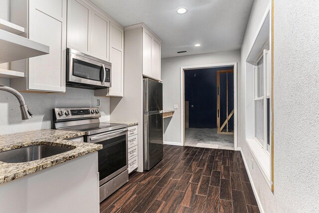 62711 Balk Rd, Sturgis, MI 49091 - kitchen featuring appliances with stainless steel finishes, a sink, open shelves, dark wood-style floors, and recessed lighting