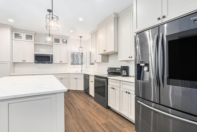62711 Balk Rd, Sturgis, MI 49091 - kitchen with appliances with stainless steel finishes, a sink, dark wood-style flooring, hanging light fixtures, and glass insert cabinets