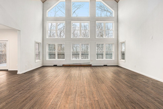 62711 Balk Rd, Sturgis, MI 49091 - unfurnished living room with a high ceiling, dark wood finished floors, and baseboards