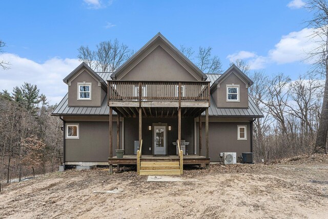 62711 Balk Rd, Sturgis, MI 49091 - back of house featuring metal roof, stucco siding, and central AC