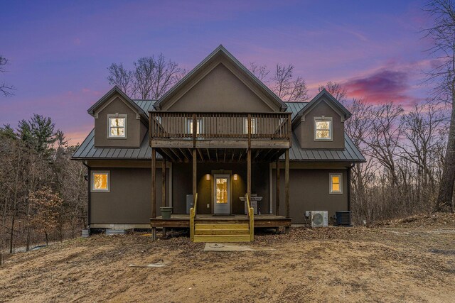 62711 Balk Rd, Sturgis, MI 49091 - rear view of house with metal roof, ac unit, central air condition unit, stucco siding, and a standing seam roof
