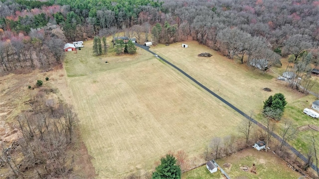 aerial view of property's location featuring rural landscape and a forest