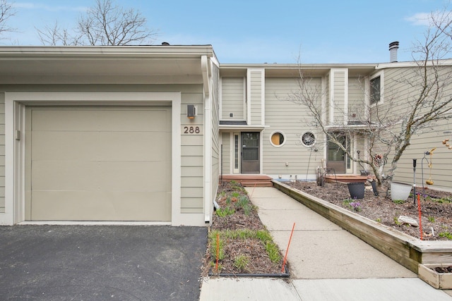 288 Whitlock St, Saline, MI 48176 - townhome / multi-family property with asphalt driveway and a garage