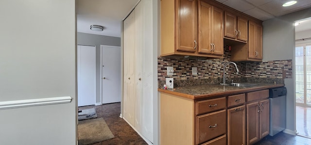 889 Kirts Blvd, Troy, MI 48084 - kitchen featuring tasteful backsplash, a sink, dark countertops, dishwasher, and brown cabinets