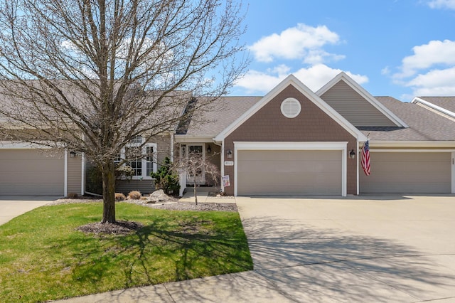 view of front of property featuring a garage, roof with shingles, and driveway