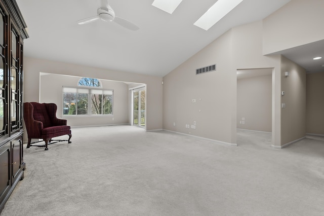 living area featuring a ceiling fan, light colored carpet, visible vents, high vaulted ceiling, and baseboards