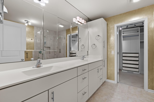 bathroom featuring double vanity, tile patterned floors, a sink, and a stall shower