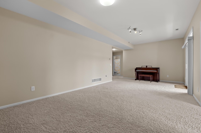 unfurnished living room with baseboards, carpet, and visible vents