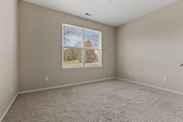 carpeted empty room with baseboards and visible vents