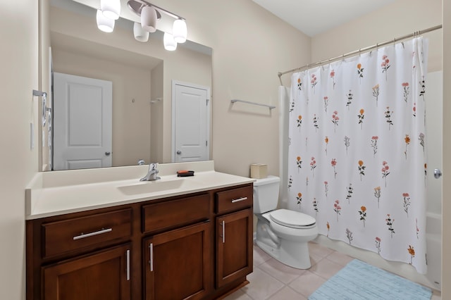 full bath with toilet, tile patterned floors, shower / bath combo with shower curtain, and vanity