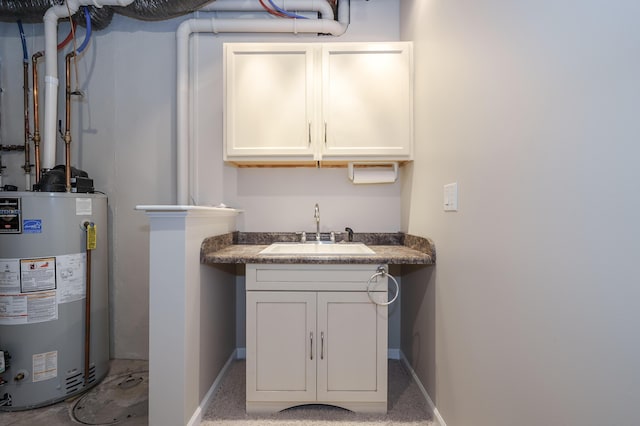 interior space with baseboards, a sink, wet bar, and water heater