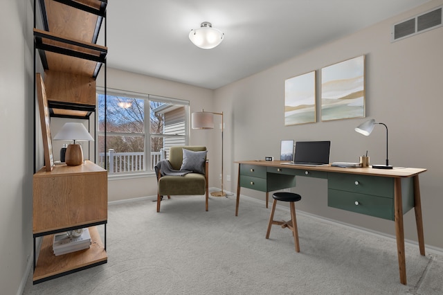 carpeted home office featuring visible vents and baseboards