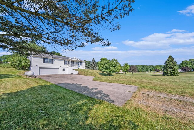 view of yard with driveway and a garage