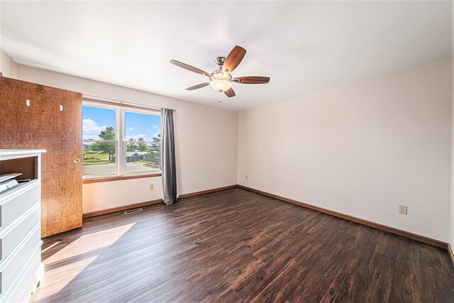 unfurnished room with visible vents, baseboards, ceiling fan, and wood finished floors