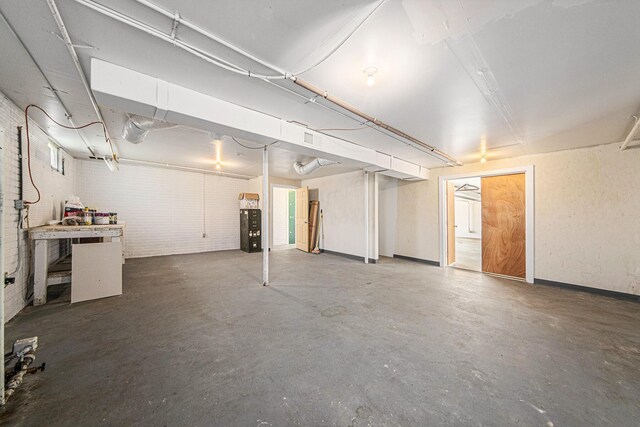unfinished basement featuring brick wall