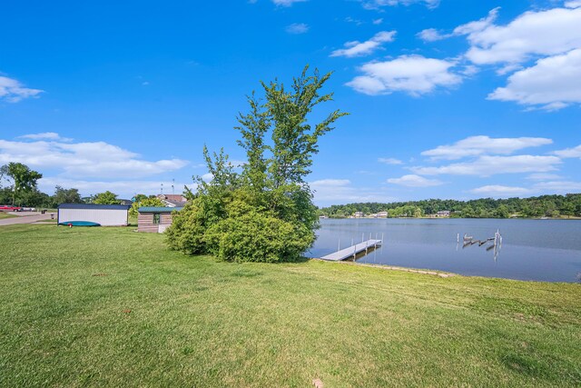 view of yard featuring a water view and a boat dock