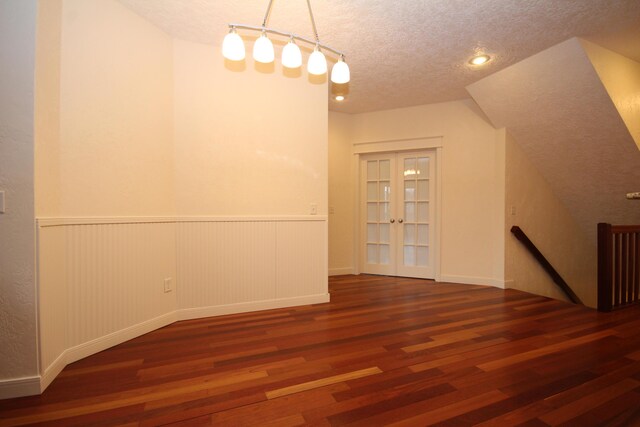 14224 Bridgeview Pointe, Vicksburg, MI 49097 - unfurnished dining area featuring wood finished floors, french doors, wainscoting, a textured ceiling, and track lighting