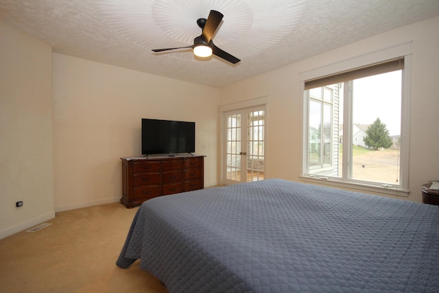 14224 Bridgeview Pointe, Vicksburg, MI 49097 - bedroom featuring french doors, light colored carpet, baseboards, a textured ceiling, and ceiling fan