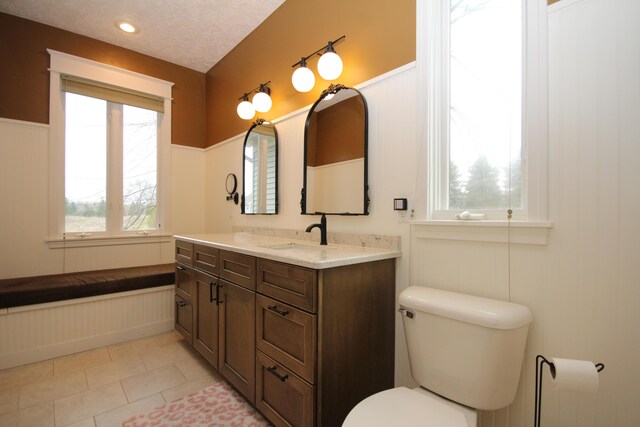 14224 Bridgeview Pointe, Vicksburg, MI 49097 - bathroom with toilet, wainscoting, vanity, and tile patterned floors