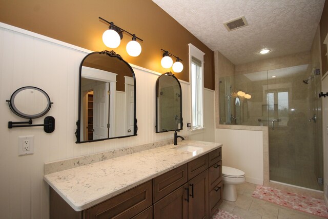 14224 Bridgeview Pointe, Vicksburg, MI 49097 - full bath featuring a shower stall, toilet, vanity, a textured ceiling, and tile patterned flooring