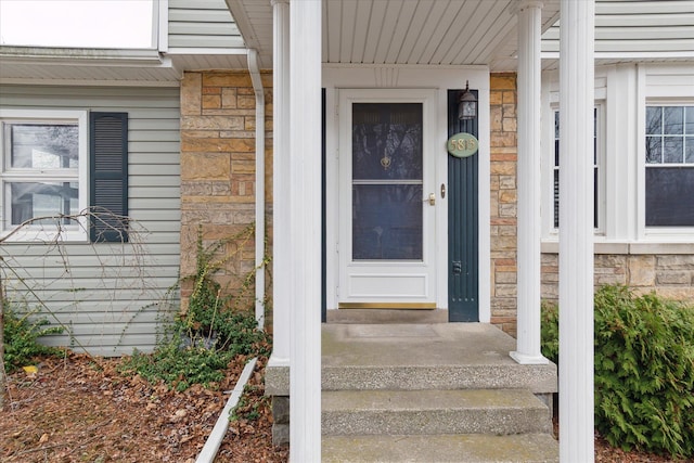 doorway to property with stone siding