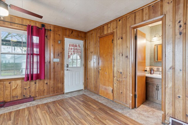 entrance foyer featuring plenty of natural light, visible vents, and wood walls