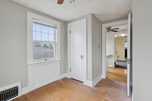 unfurnished bedroom with baseboards, visible vents, light wood-type flooring, and a ceiling fan