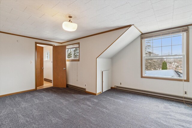 additional living space featuring baseboards, carpet flooring, and a baseboard radiator