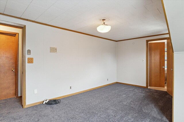 carpeted empty room with crown molding and baseboards